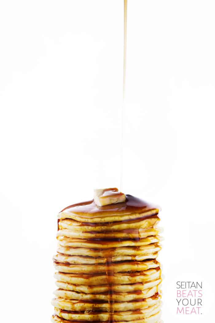 Tall stack of pancakes with syrup