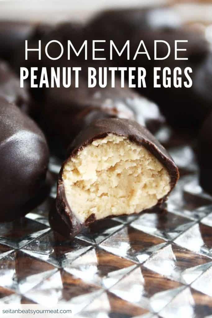 Peanut butter eggs on glass dish with a bite out of one to show insides with text "Homemade Peanut Butter Eggs"