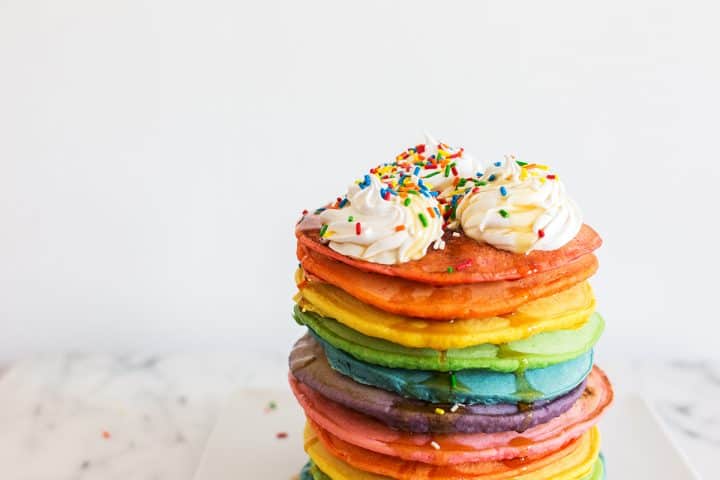 Tall stack of rainbow pancakes