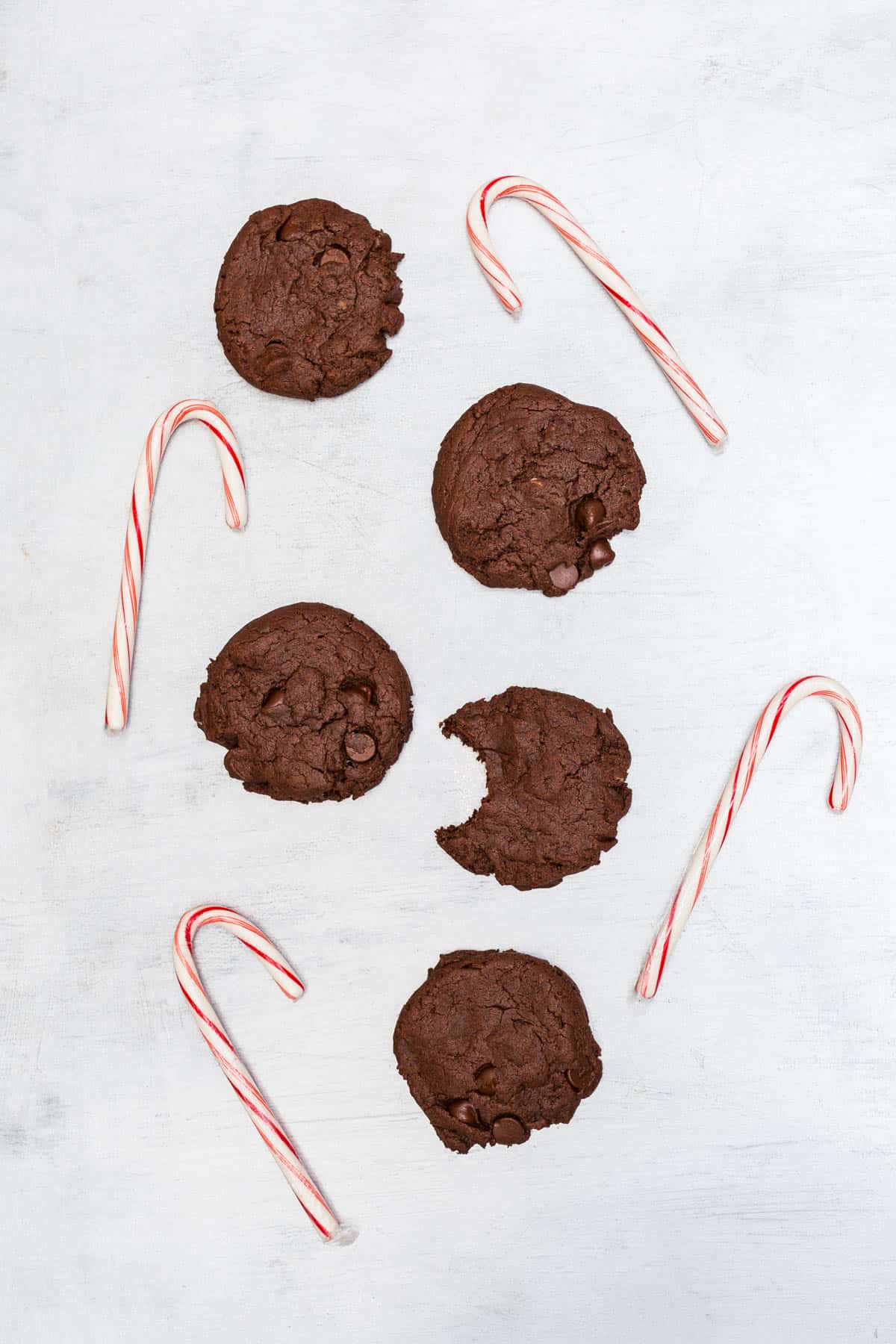 Chocolate cookies on silver background with candy canes