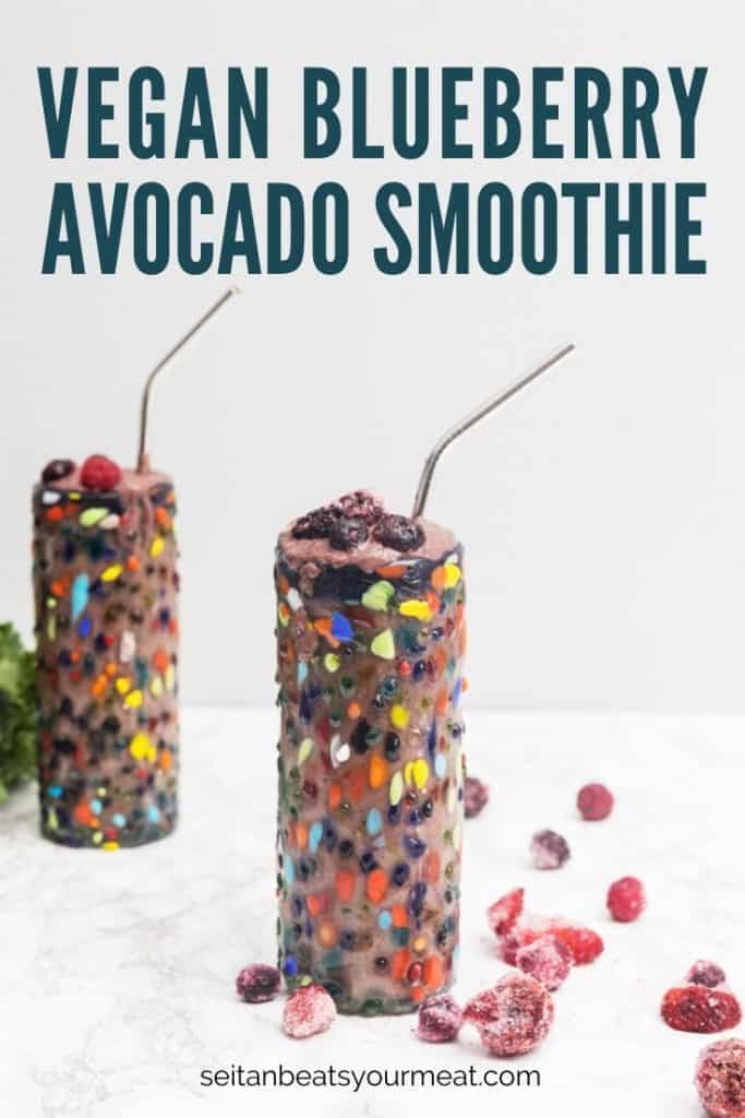 Blueberry avocado smoothie in colorful glass on marble surface