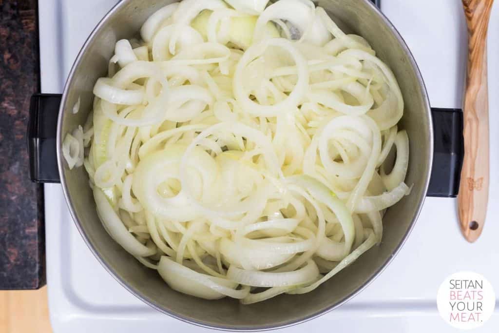 Onions cooking in large pot on stove