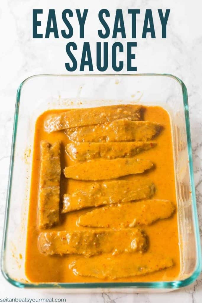 Seitan marinating in glass dish with text "Easy Satay Sauce"