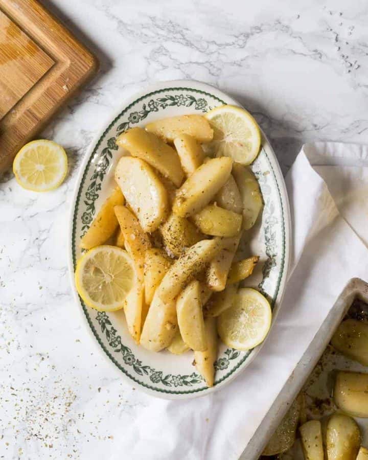 Oval plate with Greek lemon potatoes with lemon slices
