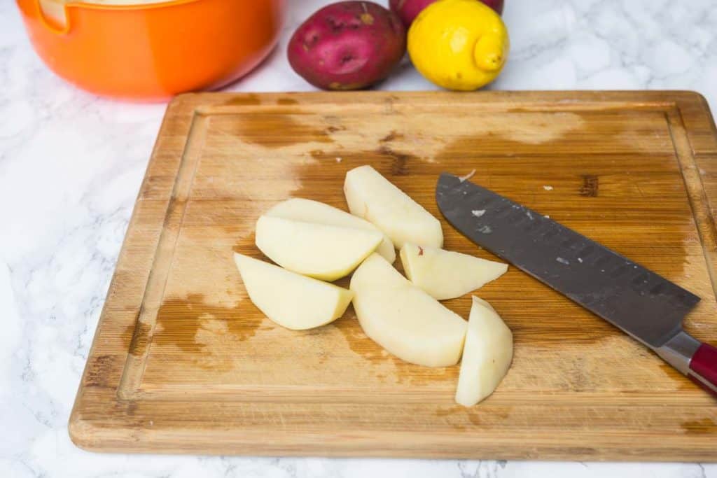 Potato wedges on wooden cutting board