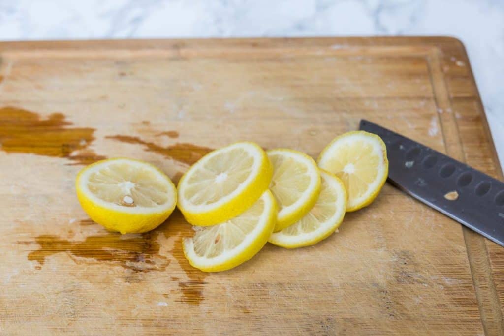 Lemon slices on wooden cutting board