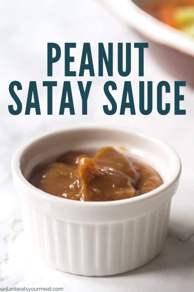 Cup of peanut sauce with text "Peanut Satay Sauce"