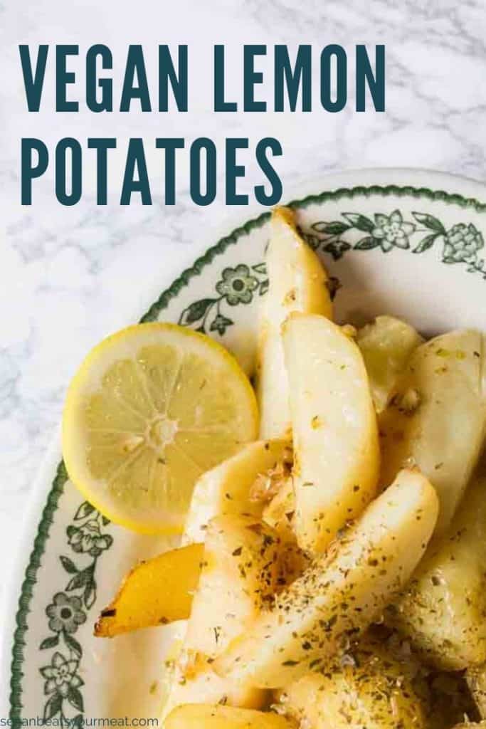 Oval plate with Greek lemon potatoes with lemon slices with text "Vegan Lemon Potatoes"