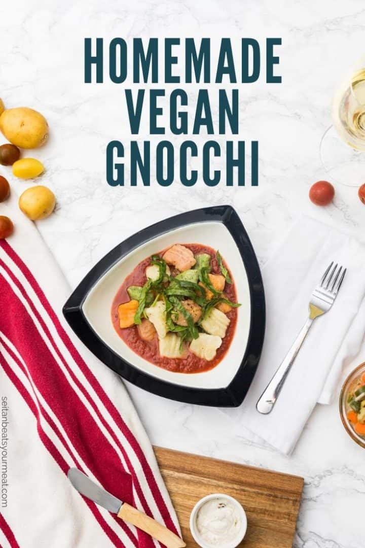 Bowl of gnocchi with tomato sauce in table setting with text "Homemade Vegan Gnocchi"
