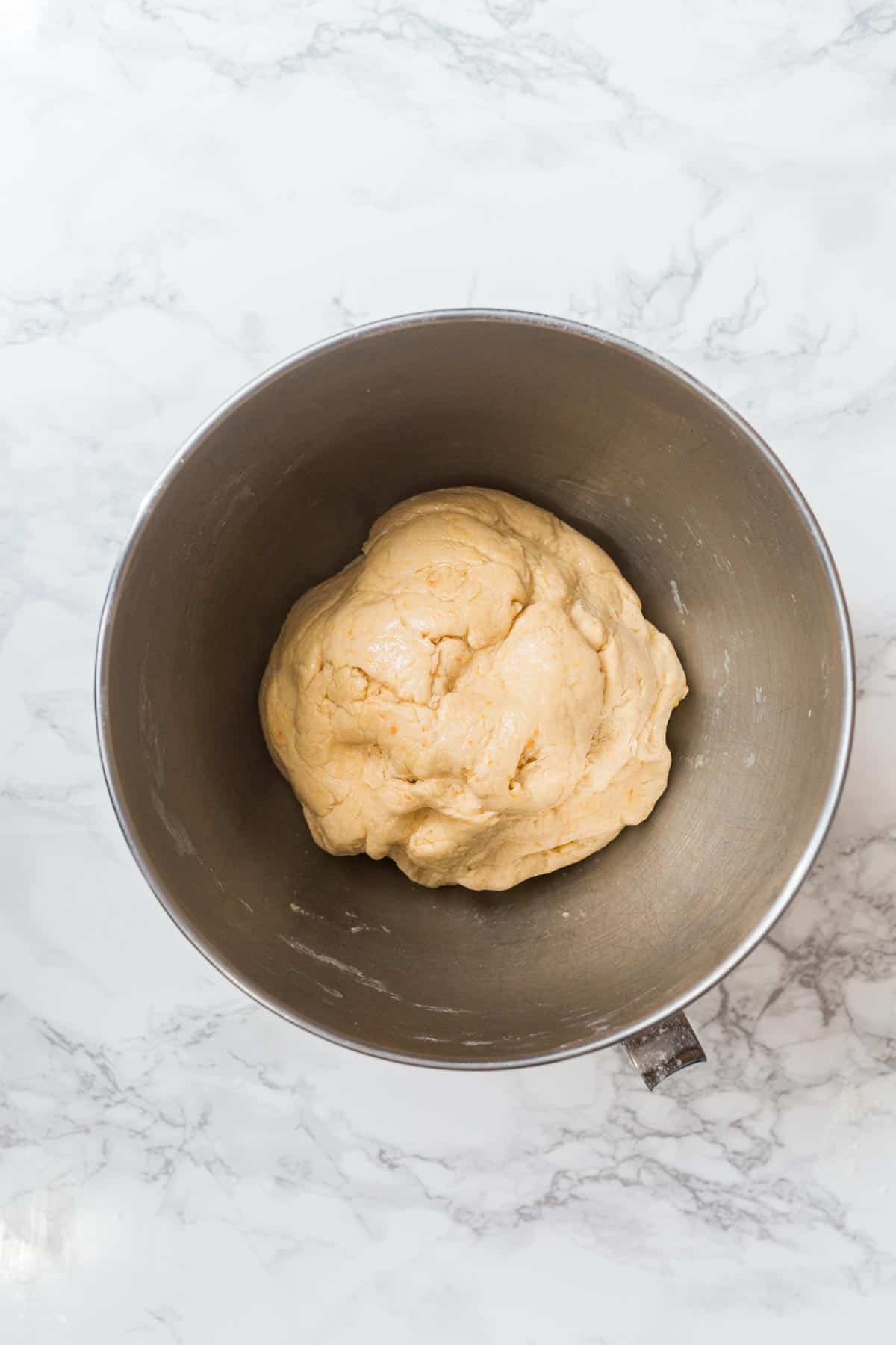 Bread dough in metal bowl on counter