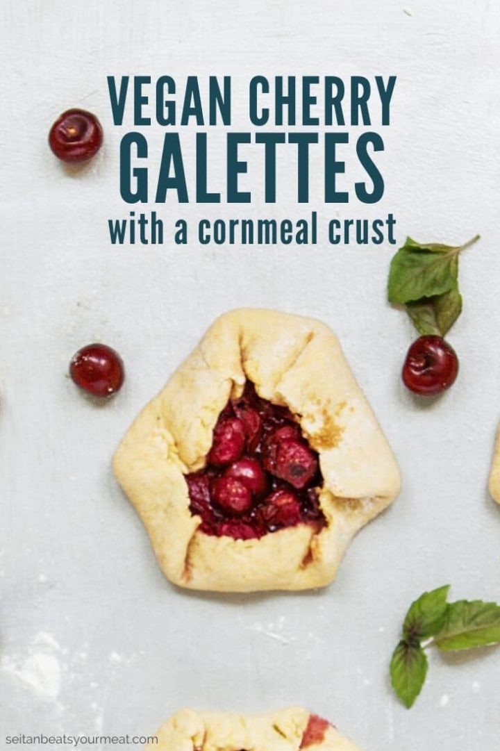Cherry pastry on gray background with text "Vegan Cherry Galettes with a cornmeal crust"