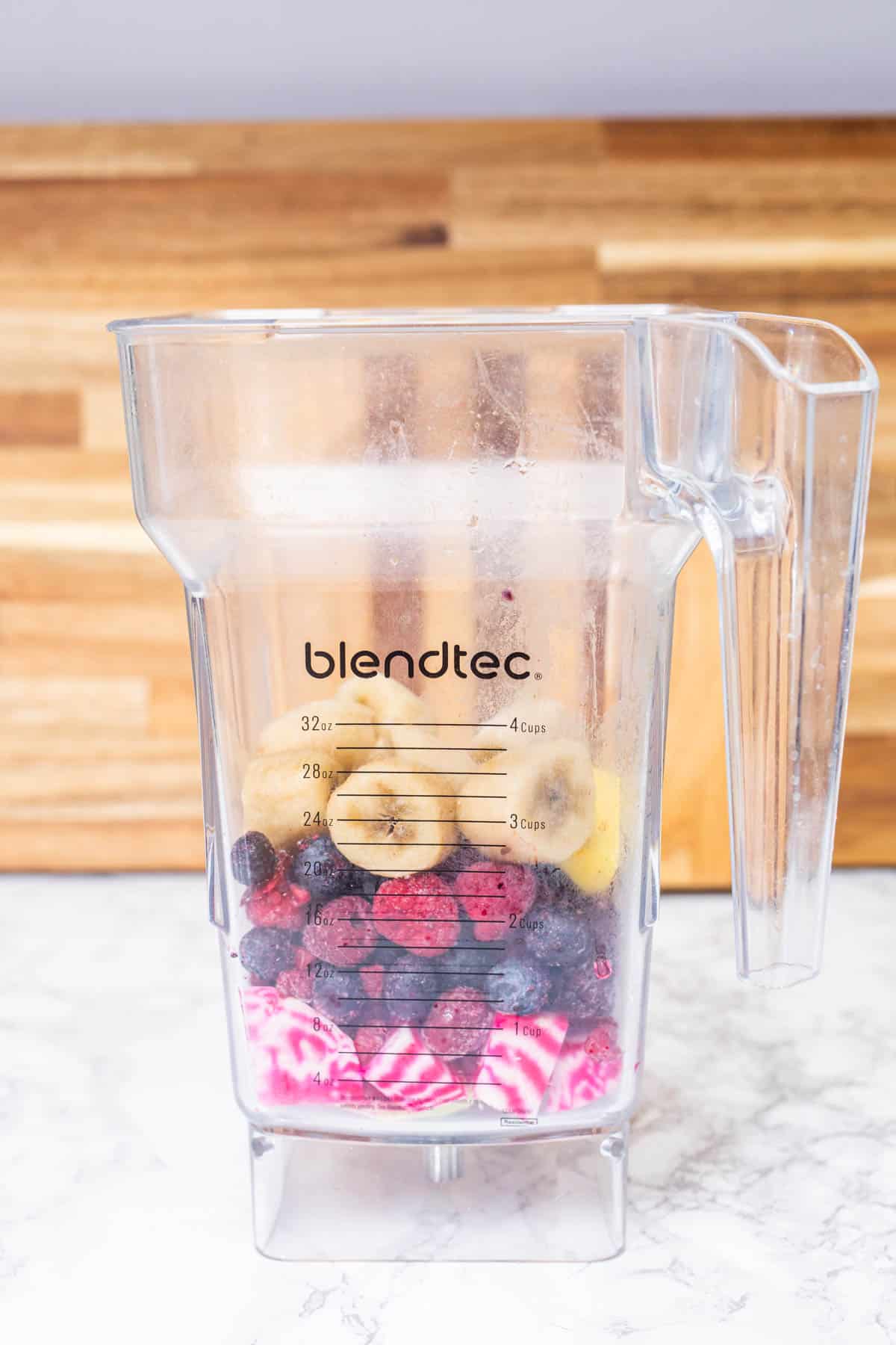 Banana, berries, and chopped beets in blender jar