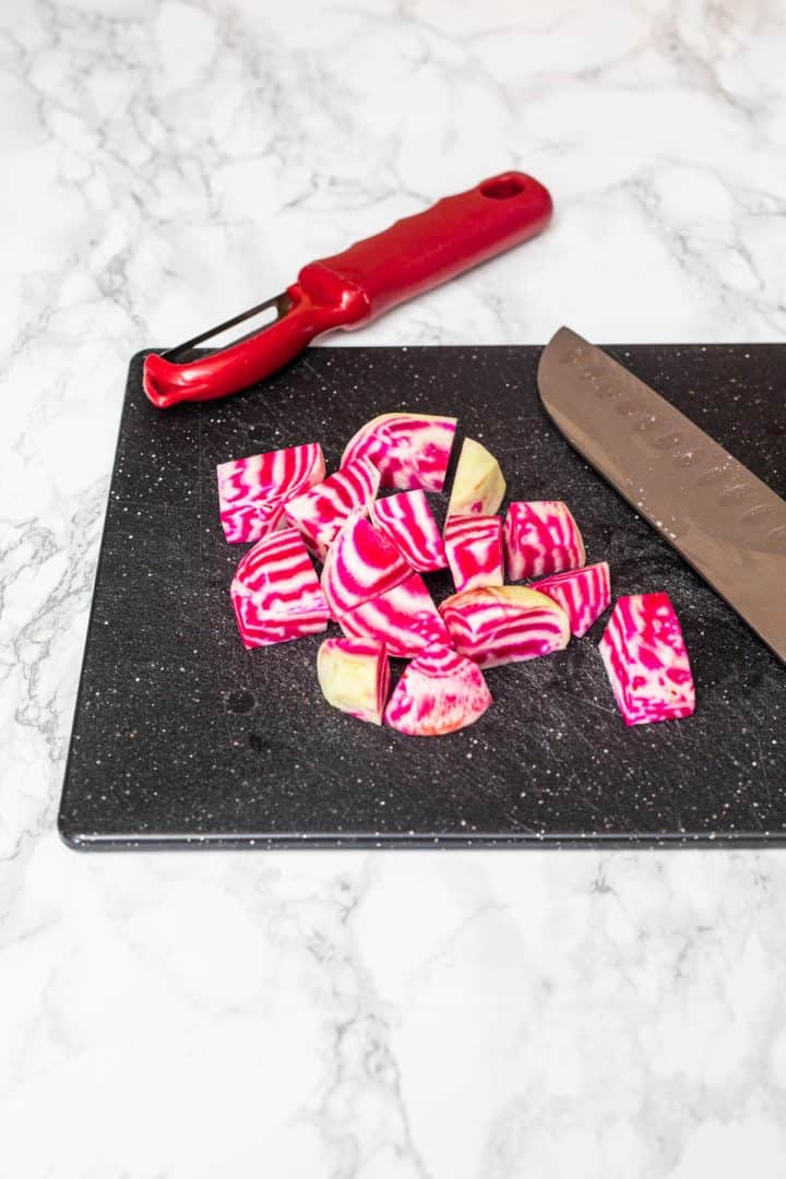 Chopped chioggia beets on cutting board