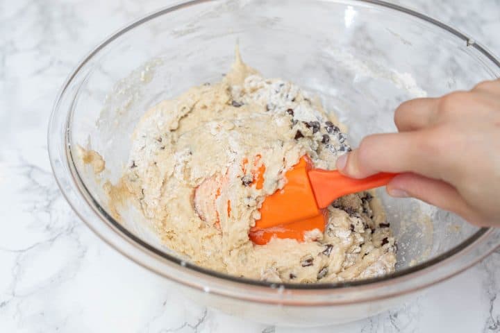 Hand mixing muffin batter with spatula