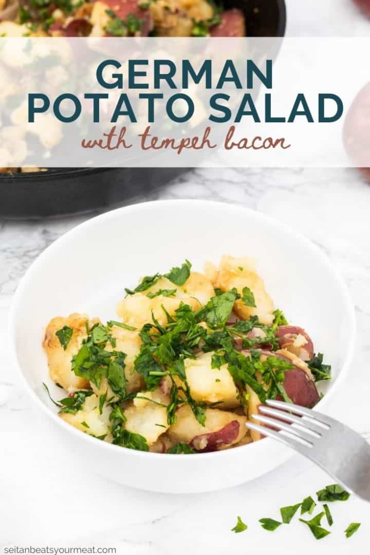 Bowl of German potato salad with fork with text "German Potato Salad with Tempeh Bacon"