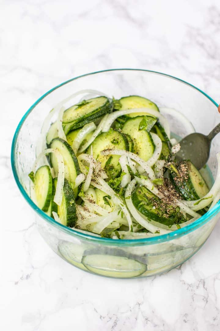 Bowl of cucumber and onion salad with fork