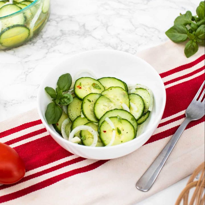 Bowl of cucumber salad on table