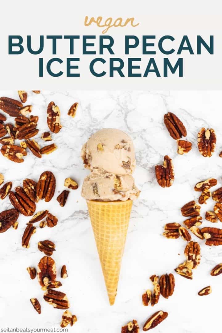 Two scoops of ice cream in sugar cone on marble surrounded by pecans with text "Vegan Butter Pecan Ice Cream"