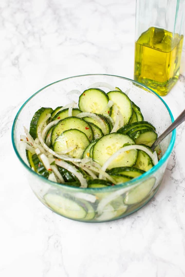 Bowl of cucumber and onion salad with olive oil
