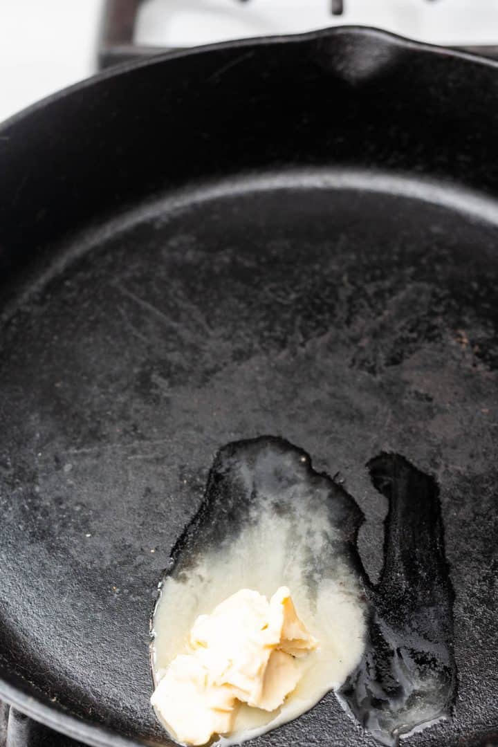 Margarine melting in large cast iron pan