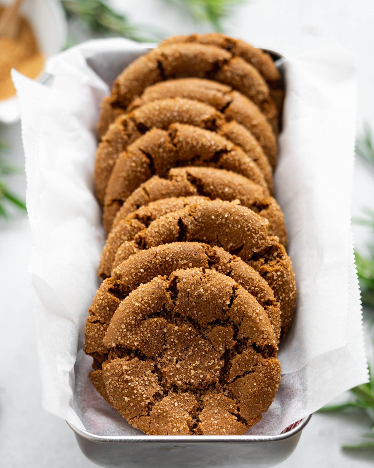 Molasses cookies lined up on narrow tray