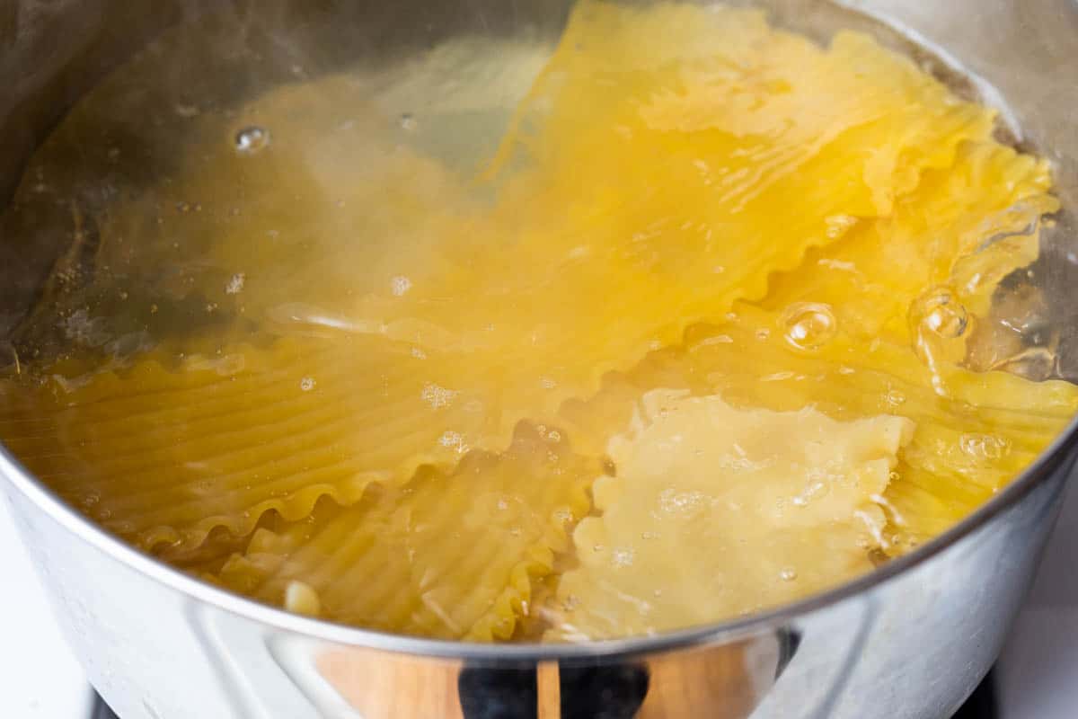 Lasagna noodles boiling in large pot