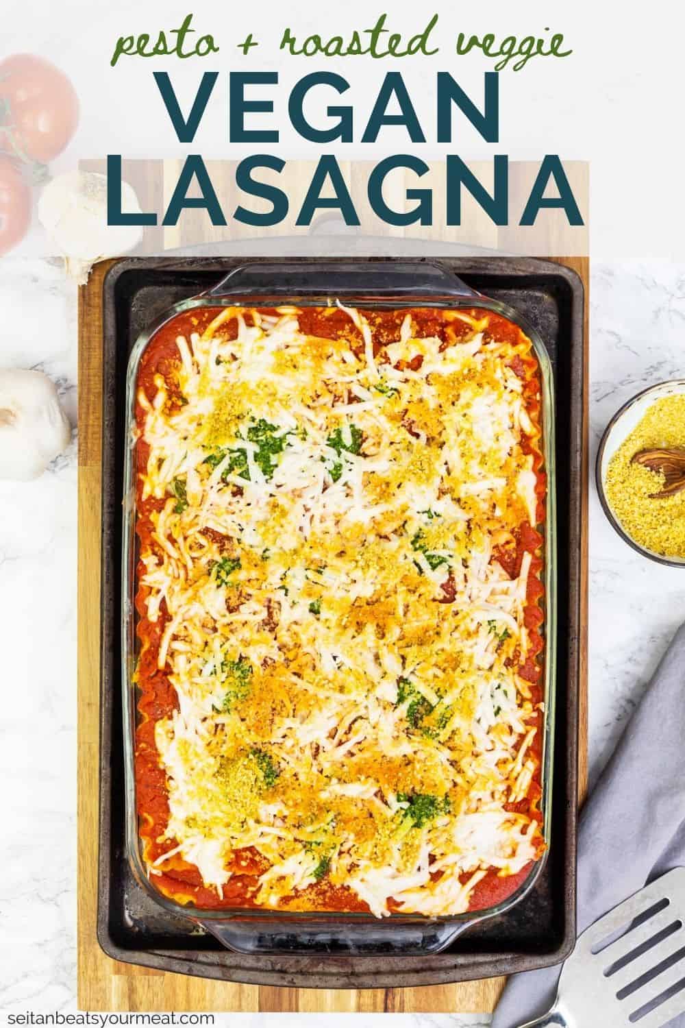 Tray of vegan lasagna on cutting board surrounded by ingredients with text "Pesto + Roasted Veggie Vegan Lasagna"