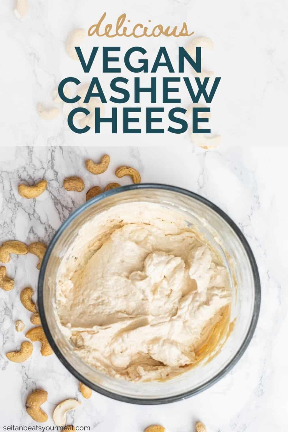 Cultured cashew cheese in glass dish surrounded by whole cashews on counter with text overlay "Delicious Vegan Cashew Cheese"