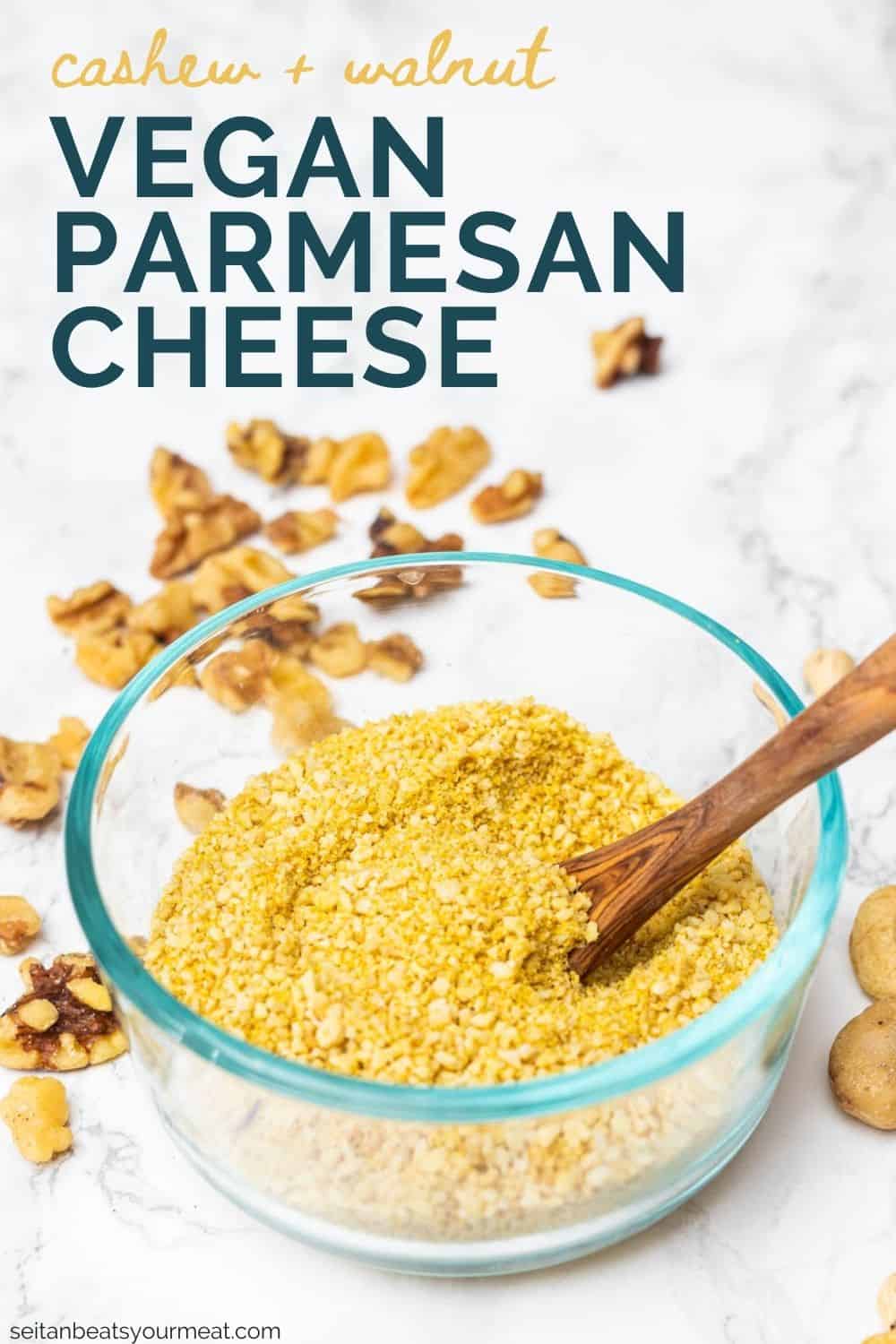 Small glass dish filled with cashew Parmesan cheese with wooden spoon with text "Cashew and Walnut Vegan Parmesan Cheese"
