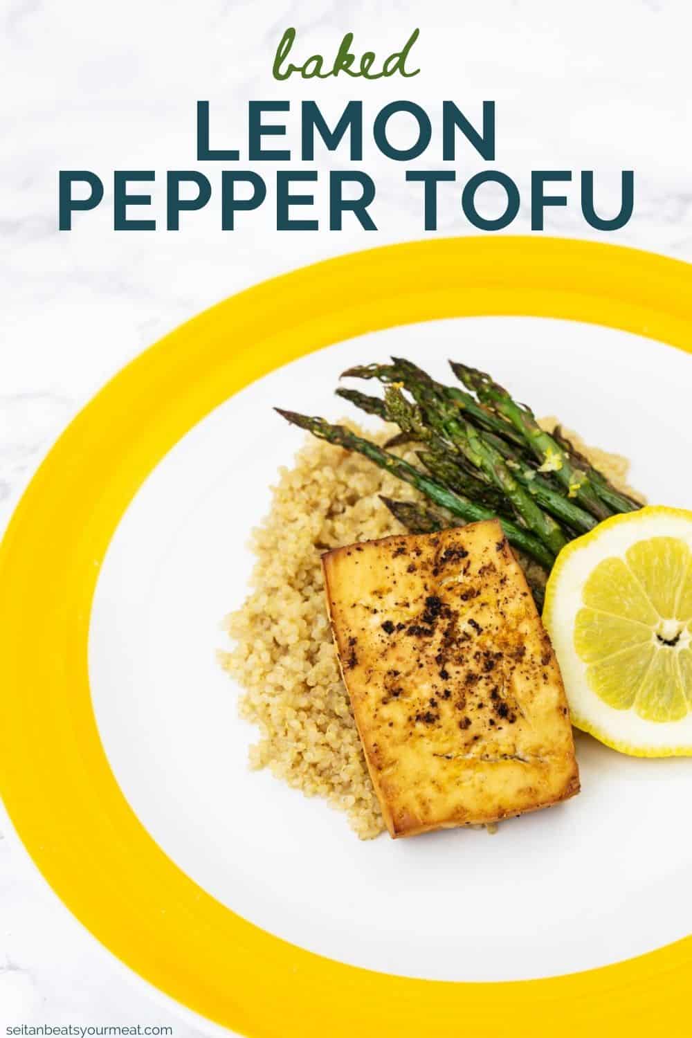 Plate of baked tofu with roasted asparagus and lemon slice on a bed of quinoa with text "Baked Lemon Pepper Tofu"