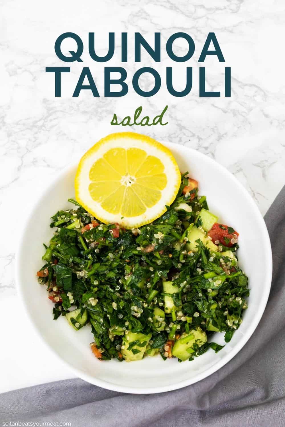 Bowl of quinoa tabbouleh with lemon slice and gray cloth napkin on white marble counter with text "Quinoa Tabouli Salad"