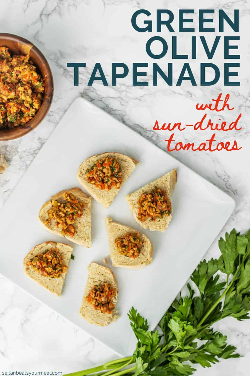 Sun-dried tomato green olive tapenade on small slices of bread on plate with text "Green Olive Tapenade with Sun-Dried Tomatoes"